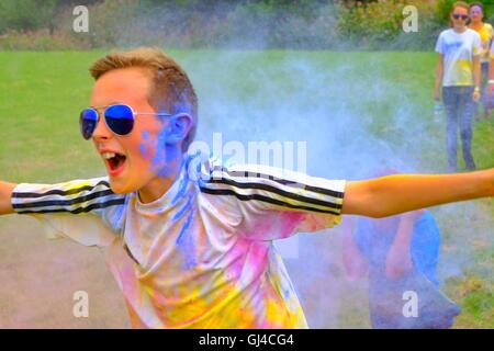 Bridport, Dorset, UK. 13th Aug, 2016. Hundreds of Powder Runners took part in the Bridport Colour Run getting covered in a variety of colours as they complete the course. The 3k untimed event passes through 9 stations where participants are showered with a riot of colours as they run, skip or hop around the course raising funds for charity. Credit:  Tom Corban/Alamy Live News Stock Photo