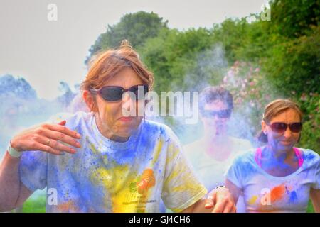 Bridport, Dorset, UK. 13th Aug, 2016. Hundreds of Powder Runners took part in the Bridport Colour Run getting covered in a variety of colours as they complete the course. The 3k untimed event passes through 9 stations where participants are showered with a riot of colours as they run, skip or hop around the course raising funds for charity. Credit:  Tom Corban/Alamy Live News Stock Photo