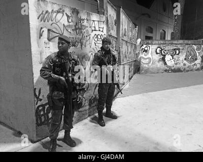 Rio de Janeiro, Brazil. 12th Aug, 2016. Armed Military patrol the streets outside the east entrance to the Olympic Athletics venue, Joao Havelange Stadium, on Rua Jose dos Reis. Credit:  PictureScotland/Alamy Live News Stock Photo