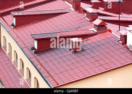 new red metal tiled roofs with dormer windows and chimneys Stock Photo