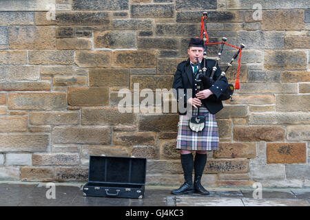 Man playing bagpipes in Edinburgh, Scotland, UK Stock Photo