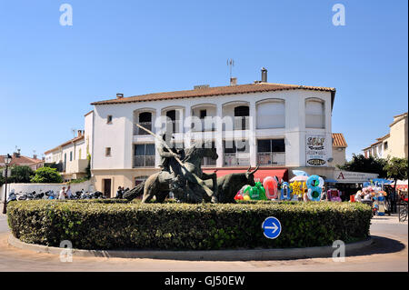 Statue of Guardian guiding a bull on the roundabout to the city center Camarguaise city of Saintes-Maries-de-la-Mer. Stock Photo