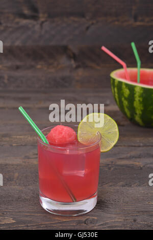 Watermelon smoothie with straws on rustic table Stock Photo