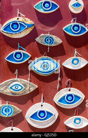 Handmade evil eye beads made of ceramics hanged on the wall for sale Stock Photo