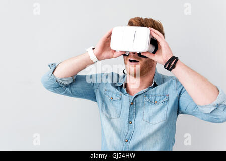 Pleasant bearded man using virtual reality device Stock Photo