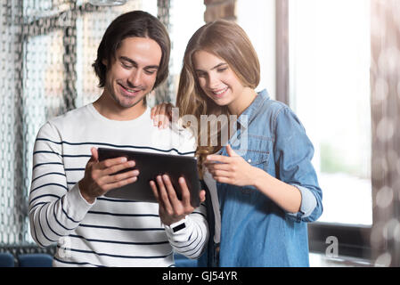 Cheerful couple using laptop Stock Photo