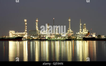 oil refinery along the river with reflection Stock Photo