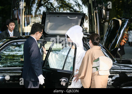 The, bride and groom,at, bride,entering,a,special,wedding,taxi,car,with,roof,opening,for,costume,a traditional Japanese Shinto,wedding,ceremony,Tokyo, Stock Photo