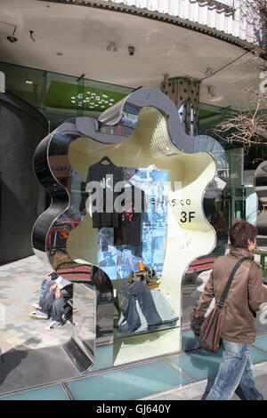 Jeans on display within this metal display 'tree' outside of Laforet store at the major landmark junction of Meiji-dori Avenue a Stock Photo