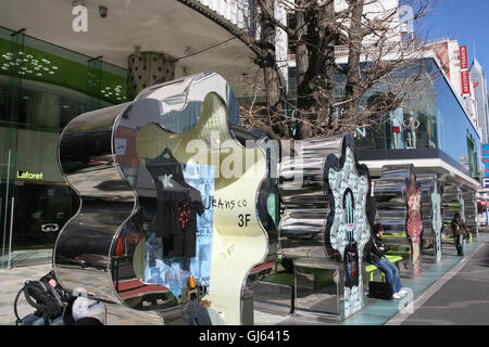 Jeans on display within this metal display 'tree' outside of Laforet store at the major landmark junction of Meiji-dori Avenue and Omotesando Avenue. Stock Photo