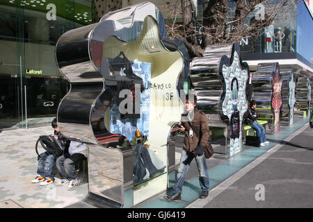 Jeans on display within this metal display 'tree' outside of Laforet store at the major landmark junction of Meiji-dori Avenue a Stock Photo