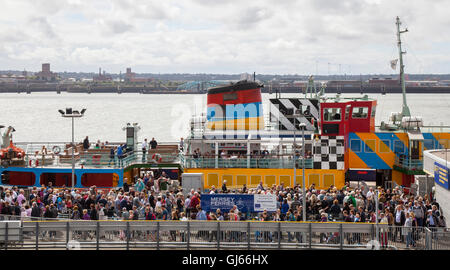 Summer season crowds on the Dazzle Mersey Ferry, a European Union Development Fund project,  at the Pierhead, Waterfront, Liverpool, Merseyside, UK Stock Photo