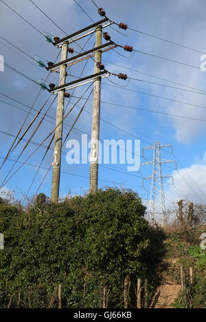 Multiple power lines in rural England, distribution poles and larger pylons. 30th January 2015 Stock Photo