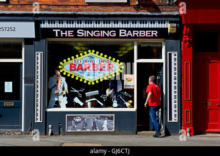 Man walking in to the Singing Barber, Middle Street South, Driffield, East Yorkshire, England UK Stock Photo
