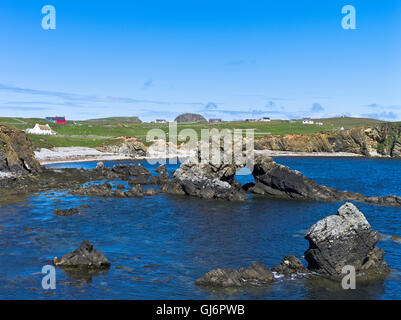 dh South Harbour FAIR ISLE SHETLAND Sea arch in bay croft cottage houses rocky shoreline scotland