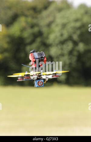 Drone Racing Queen's Cup 2016.  FPV, First Person View Drone racer pilot Gary Kent flies a quadcopter drone at the flightline. Stock Photo