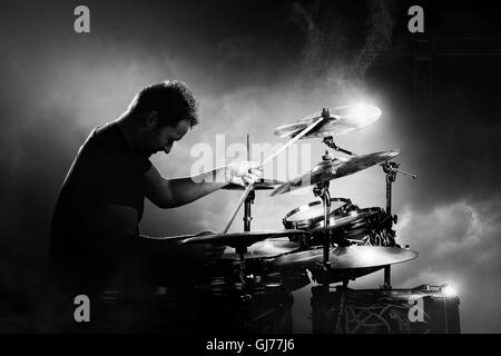 Drummer playing the drums with smoke and powder in the background Stock Photo