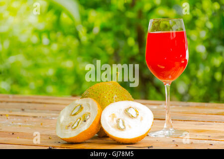 Green baby Jackfruit and juice on wooden background.fruit for health and stillife.1 Stock Photo