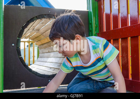 boy crawling through tunnel in playground Stock Photo - Alamy