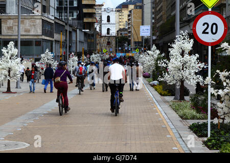 Cyclists riding along pedestrian street in city centre, Bogotá, Colombia Stock Photo