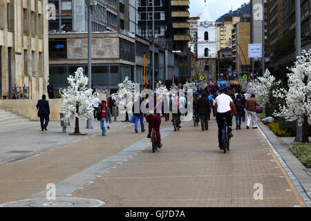 Cyclists riding along pedestrian street in city centre, Bogotá, Colombia Stock Photo