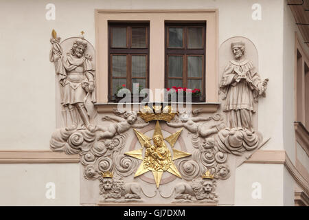 Saint Wenceslas and Saint John of Nepomuk depicted on the House at the Golden Well in Karlova Street in Prague, Czech Republic. Stock Photo