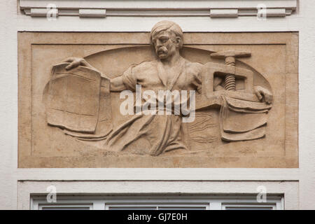 Printer working on the printing press depicted the Art Nouveau revenue house in Wenceslas Square in Prague, Czech Republic. Stock Photo