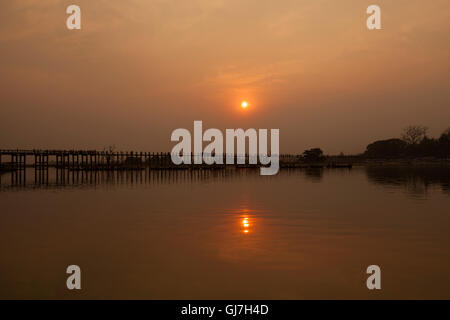 Sunset over the historic wooden U Bein Bridge near Mandalay in Burma