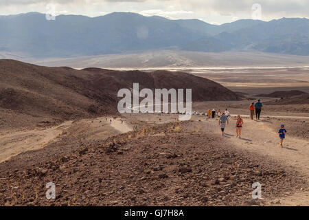 Tourists hiking up to the volcanic and sedimentary hills near Artist's Palette in Death Valley National Park, California, USA Stock Photo