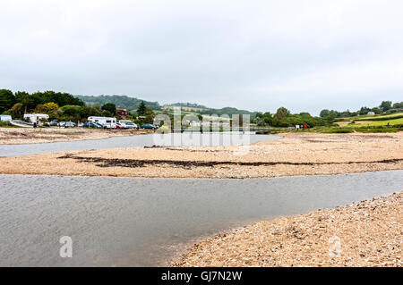 Charmouth beach is divided into two by the mouth of the River Char which is often dammed by the beach forming a lagoon Stock Photo