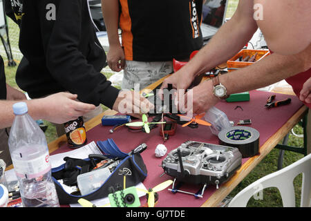 Drone Racing Queen's Cup 2016.  Drone racer pilots at the flightline prepare for flight prior to racing. Stock Photo
