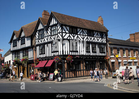 Black and white half timbered Costa coffee shop Stratford-upon-Avon with shoppers walking in street Warks UK Stock Photo