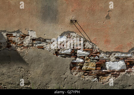 Exposed bricks show through the plaster on a deserted farmhouse in Pisa Stock Photo