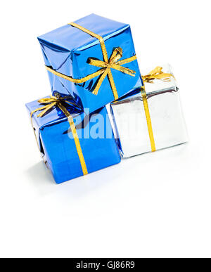 Series of miniature, colorful gift boxes, some on colored backgrounds, some on white. Stock Photo