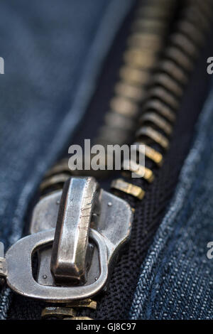 Close up and detailed shot of a metallic zip on denim Stock Photo