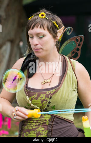 Burley, Hampshire, UK. 13th Aug, 2016. Woman dressed as elf fairy blowing bubbles for the child fairies to catch at the New Forest Fairy Festival, Burley, Hampshire, UK in August  Credit:  Carolyn Jenkins/Alamy Live News Stock Photo