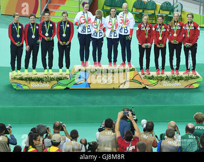 Rio de Janeiro, Brazil. 13th Aug, 2016. Team of Great Britain (C) consisting of Katie Archibald, Laura Trott, Elinor Barker and Joanna Rowsell-Shand celebrates on the podium flanked by silver medalists USA and bronze medalist Canada after winning the Women's Team Pursuit Final of the Rio 2016 Olympic Games Track Cycling events at Velodrome in Rio de Janeiro, Brazil, 13 August 2016. Photo: Felix Kaestle/dpa/Alamy Live News Stock Photo