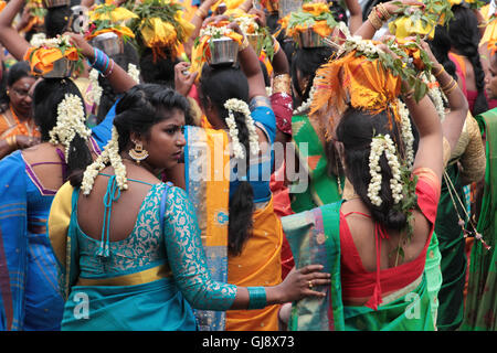 Ealing, London, UK. 14th Aug, 2016.  Women carrying pots of milk on their heads, known as paal kudam, during a chariot procession which is the culmination of the annual Shri Kanagathurkkai Amman Temple (SKAT) festival of Thaipusam in West Ealing. The festival attracts thousands of Hindu devotees to West Ealing from all over the world. Credit:  Roger Garfield/Alamy Live News Stock Photo