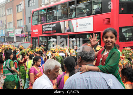 Ealing, London, UK. 14th Aug, 2016.  Women carrying pots of milk on their heads, known as paal kudam, during a chariot procession which is the culmination of the annual Shri Kanagathurkkai Amman Temple (SKAT) festival of Thaipusam in West Ealing. The festival attracts thousands of Hindu devotees to West Ealing from all over the world. Credit:  Roger Garfield/Alamy Live News Stock Photo