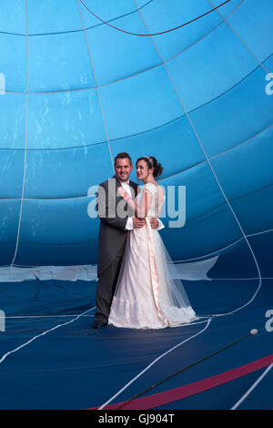 Bristol,UK,14th August 2016,Newlywed couple, Marcus Forsey and Melissa Forsey, pose inside a Royal Navy Balloon at the Bristol International Balloon Fiesta before their fligh Credit: Keith Larby/Alamy Live News Stock Photo