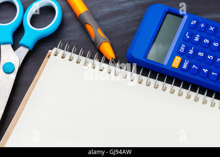 calculator and stationery close-up on a black background Stock Photo