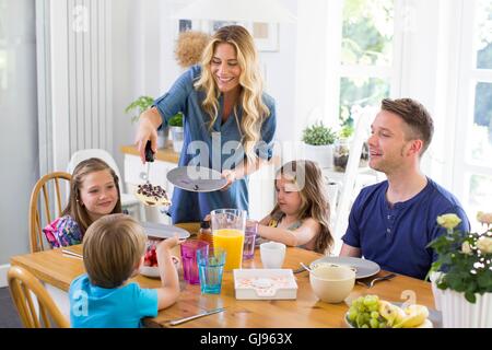 PROPERTY RELEASED. MODEL RELEASED. Family at dining table having a meal. Stock Photo