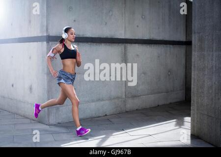 Woman wearing sports clothing running and isolated on white background for  composites. She is an active and fit Caucasian female who looks like she i  Stock Photo - Alamy