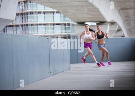 MODEL RELEASED. Two young women racing. Stock Photo