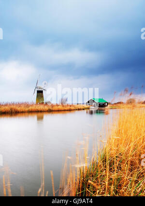 Moody sky on the River ant as the clouds come in over the reed beds near Thurne Mill Stock Photo