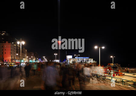 Crowds gather to watch the British Airways i360 observation tower light show on it's opening night. Brighton & Hove seafront, UK Stock Photo
