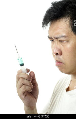 asian-man-holding-syringe-with-green-liquid-gj9tck.jpg