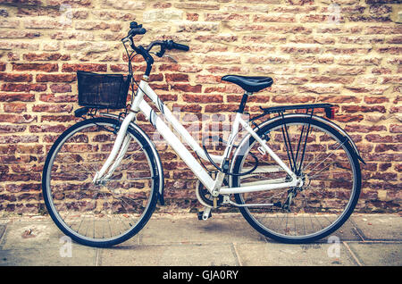 bike lean to a brick wall Stock Photo