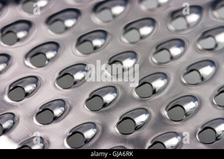 Abstract metallic surface background of cheese grater closeup Stock Photo