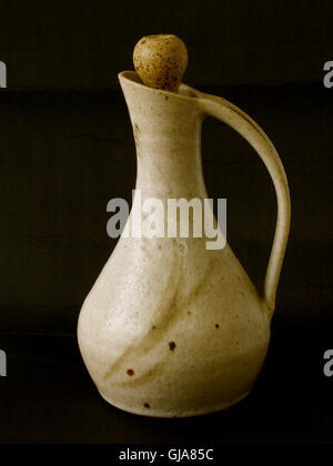 Clay pitcher with long handle and cover Stock Photo